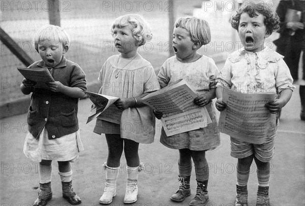 Four Young Children Singing