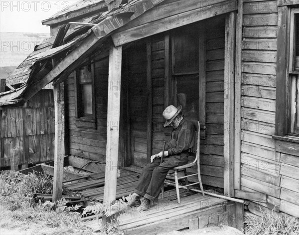 Elderly Man Doses On His Porch