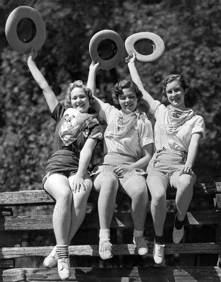 Three Cowgirls On A Fence