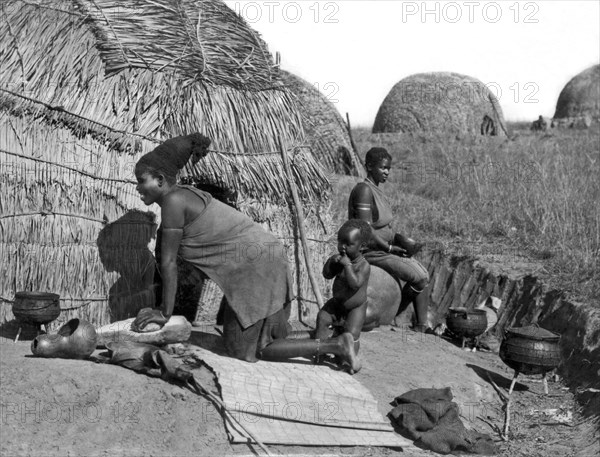 Native Woman Kneading Bread