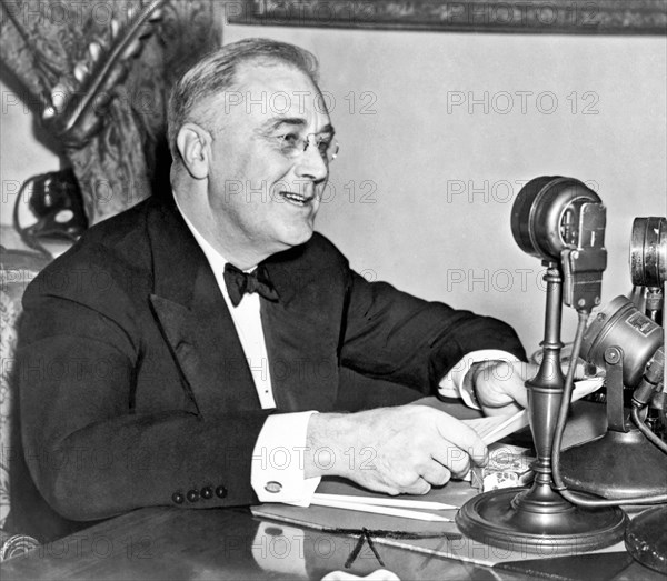 Washington, D.C.:  1937.
President Franklin D. Roosevelt, seated behind microphone, during one of his fireside chats.