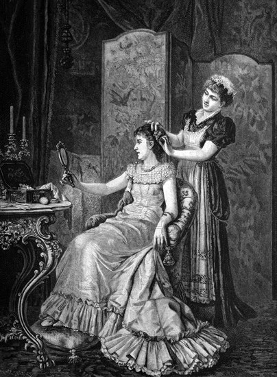 Maid combing a lady