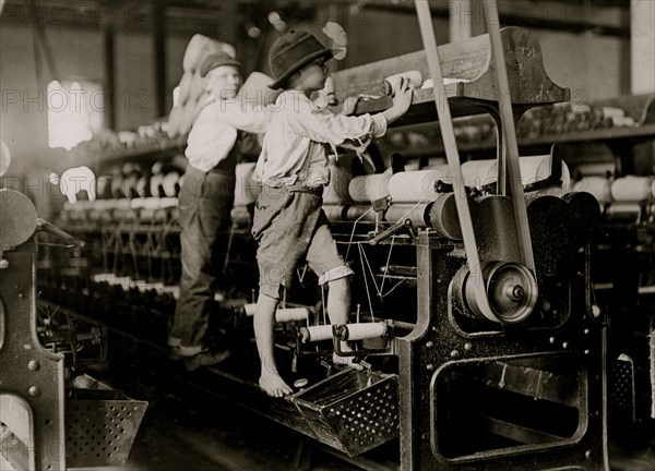 Some boys were so small they had to climb up on the spinning frame to mend the broken threads and put back the empty bobbins 1909