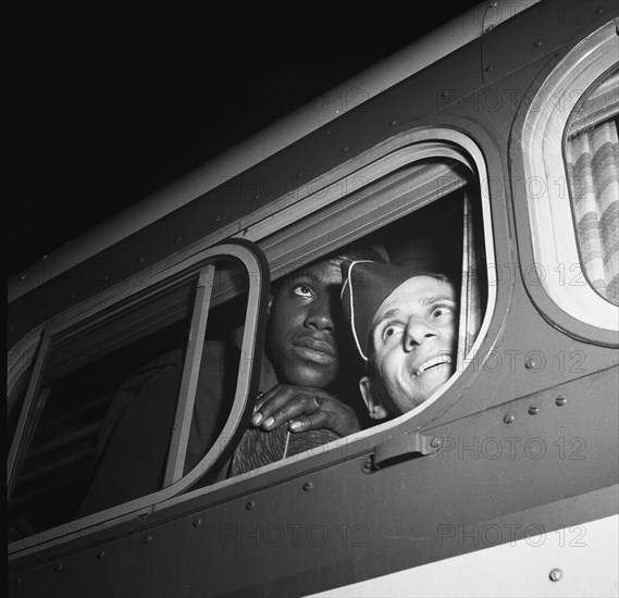 Washington, D.C. Soldiers looking out the window of the bus just before leaving the Greyhound terminal 1943