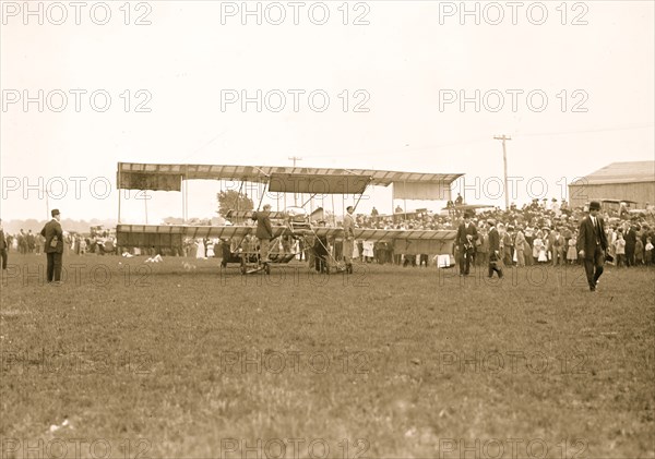 Harmon in aeroplane with crowds of onlookers