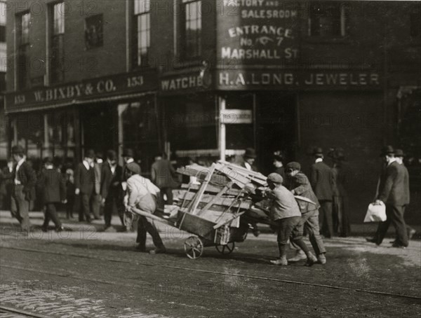 3 Boy Woodpickers Under Way lugging a cart full of firewood. 1909