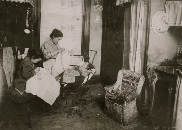 Seven year old daughter, Lorenza, embroidering ladies waists in their dirty kitchen-living room. Lorenza makes the stems of the flowers. 1912