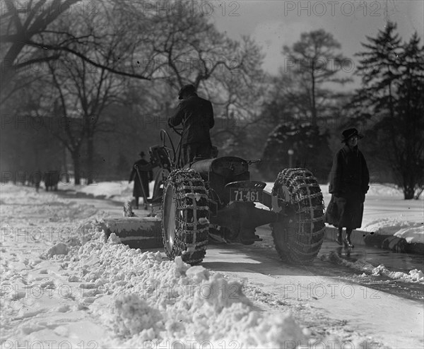 A Ford Tractor cleans snow on DC Street 19245