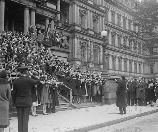 A hundred Massed Violins on the Steps of the Navy Building in Washington, DC play the Star Spangled Banner to the saluting of officials 1917