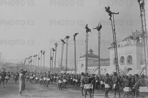 A line of dozens of high bamboo ladders are the focus of a major demonstration of the amusement of Tokyo onlookers as they watch their firefighters performs feats of daring and acrobatics.