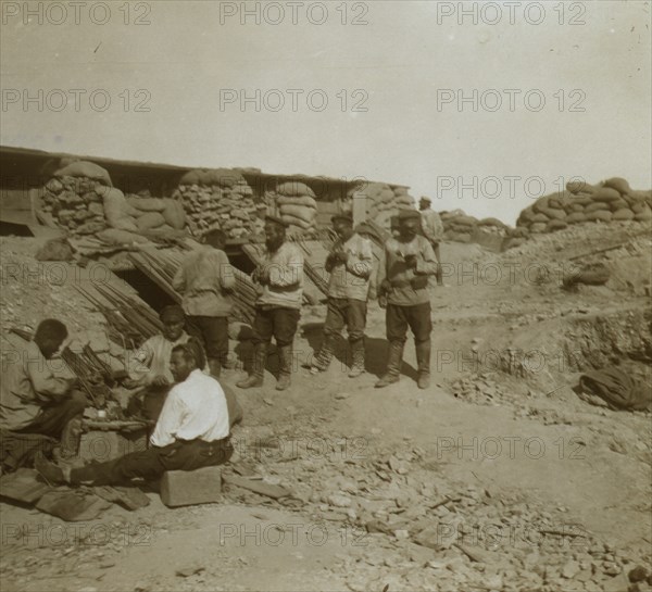 A soldier-cobbler mending boots in a Russian redoubt  1905