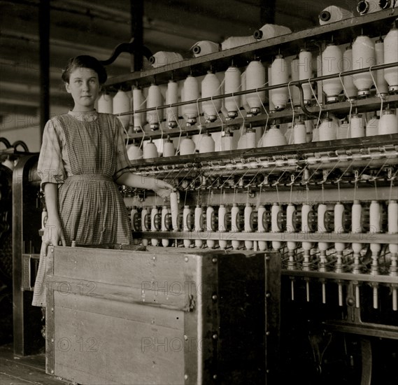 French illiterate works as a doffer or carder in a mill; she is 14 or 15 years old. 1911