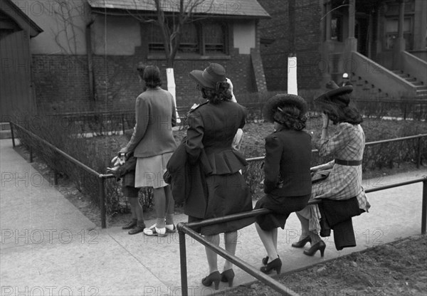 African American Girls waiting for Episcopal Church to end so they can see the processional, South Side of Chicago, Illinois 1938