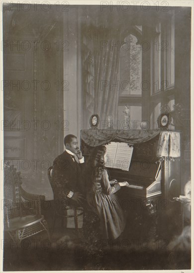 African American man giving piano lesson to young African American woman 1899