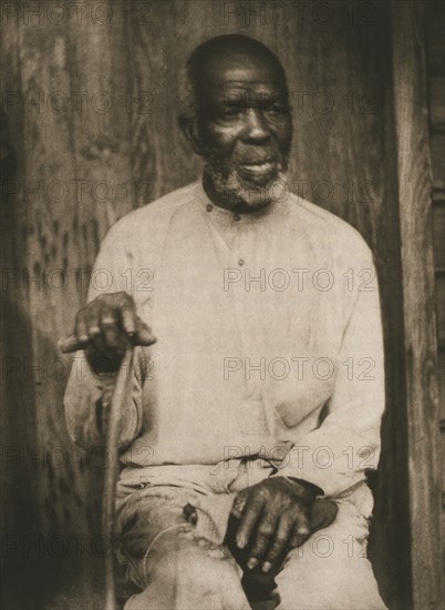 African American man hand holding cane, left hand on lap 1933