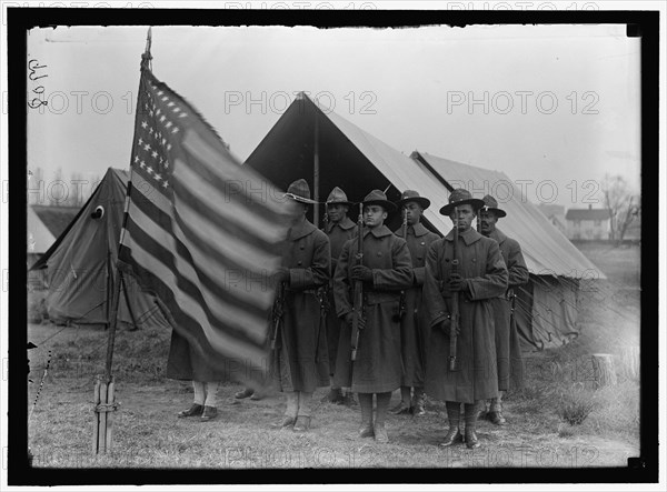 African American soldiers present arms to the Stars & Stripes 1917