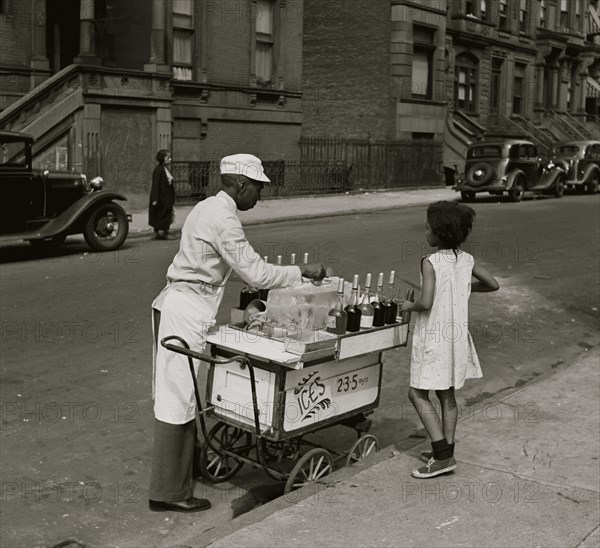 African American Vendor Sells water ice in the city on  hot day to a young black girl 1940