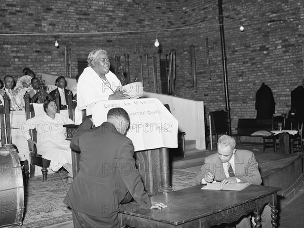 African American Woman Pastor leads her congregation in Prayer 1941