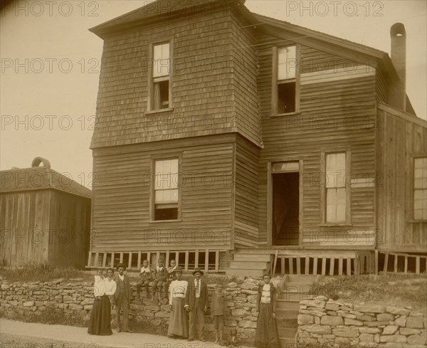 African Americans standing on sidewalk in front of house in Georgia 1899