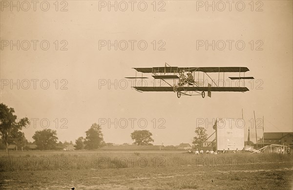 Curtiss-Herring aeroplane, in fligh over field 1909