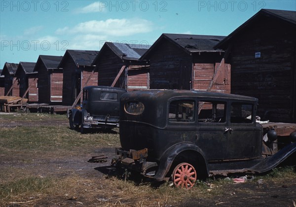 Black migratory workers by a shack, Belle Glade, 1941