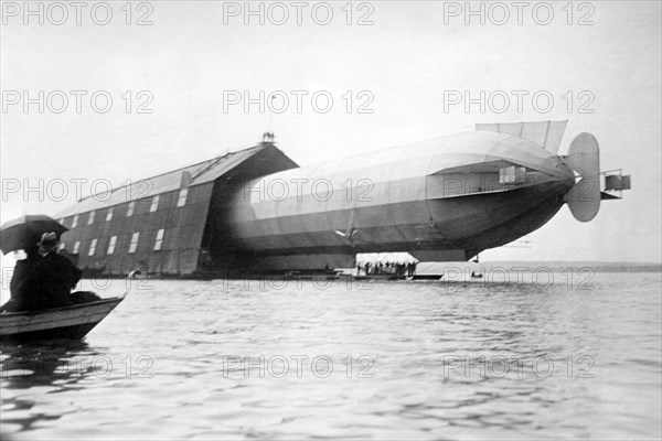 Dirigible in hanger over water