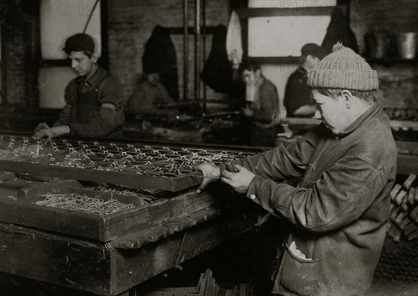 Boys "linking" bed-springs. 14 and 15 years old. 1917