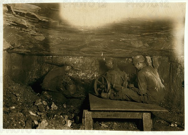 Brown Mine. Man digging coal by machinery low ceiling: 1908