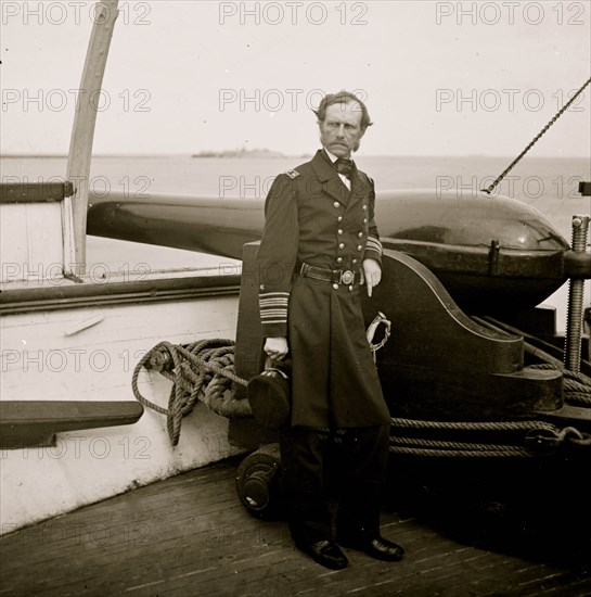 Charleston Harbor, S.C. Rear Admiral John A. Dahlgren standing by a Dahlgren gun on deck of U.S.S. Pawnee 1864