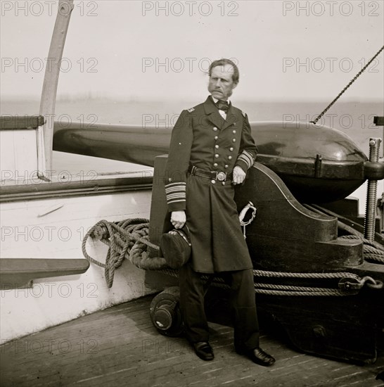 Charleston Harbor, South Carolina. Rear Adm. John A. Dahlgren standing by a Dahlgren gun on deck of U.S.S. PAWNEE 1864