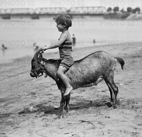 Child Placed on Goat Tears in Fear-his Mother out of the Picture looks on 1924