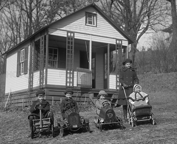 Children line up on lawn with they Toy cars, each driving them 1924