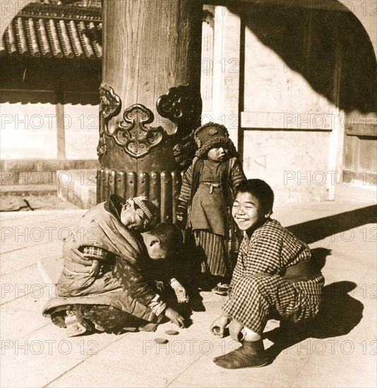 Children playing at the entrance to the temple, Nagoya, Japan 1902