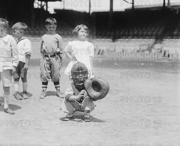 Pint sized Catcher awaits a pitch in Children's Baseball Game 1921