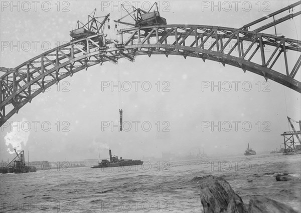 Completing the Hell Gate Railroad Bridge over the East River connecting Queens with Manhattan 1915