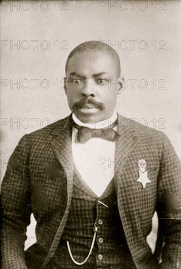 Corporal Isaiah Mays, half-length portrait, seated, facing front 1900