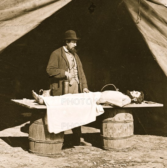 Embalming surgeon at work on soldier's body 1863