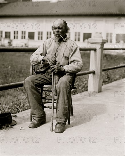 Ex-Slave - Man seated with pipe in 1920 1920