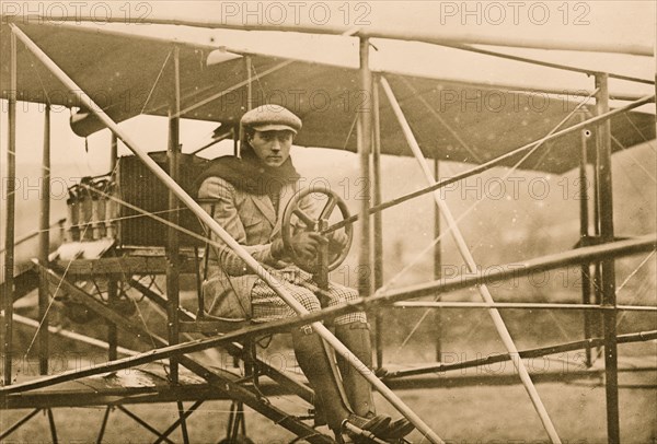 F.L. de Riemsdyk at pilot wheel of Curtiss aeroplane 1909