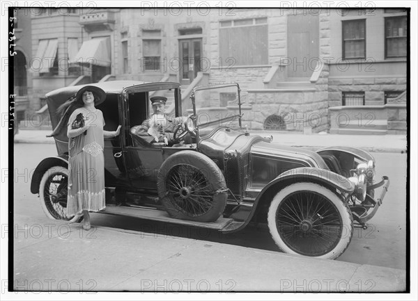 Fancy lady with chauffeur driven limousine and dog in car