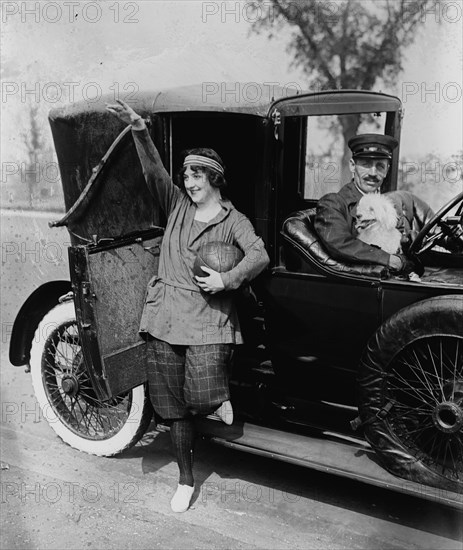 Fancy lady with chauffeur driven limousine and dog in car