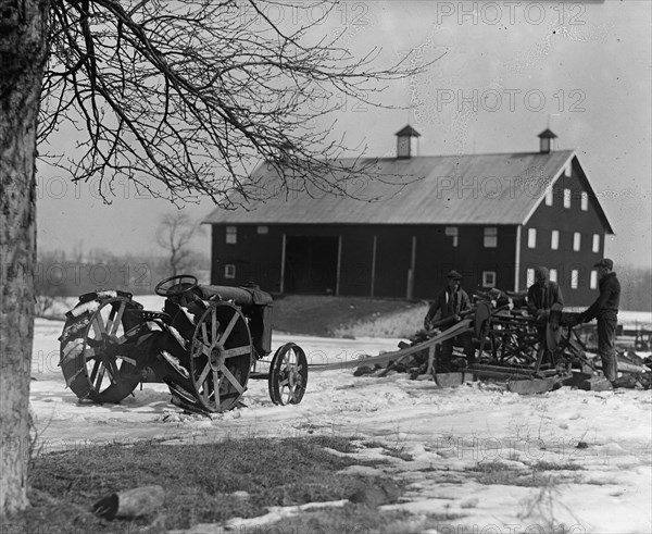 Farmer Drives Ford Tractor in yard 1924