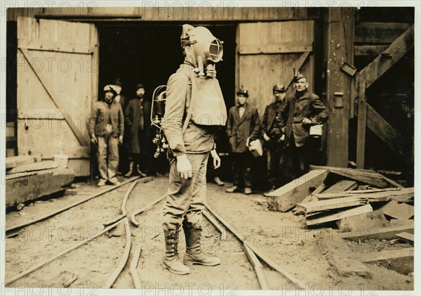 First Aid to the Injured man equipped with Draeger Oxygen Helmet. 1908