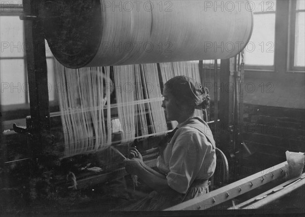 Girl at the drawing-in-frame of the weave-room, Lorraine Mills, Pawtucket, R.I.  1912