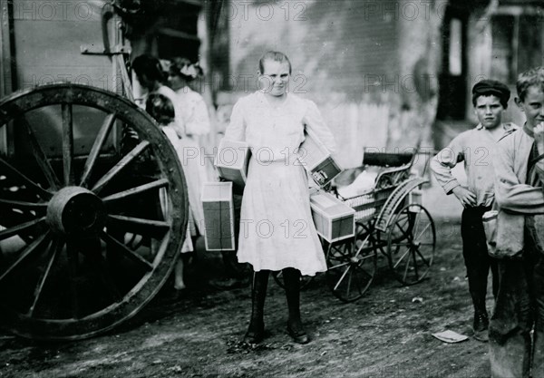 Girl with heavy load of tags. 1912