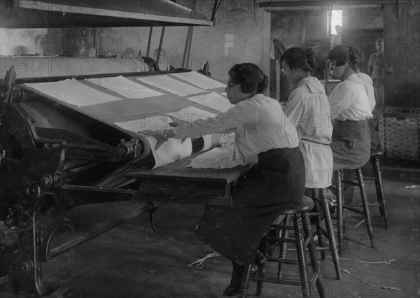 Girls working at mangle in Bonanno Laundry, 12 Foster Wharf. All are 15 years old and go to continuation school 1917