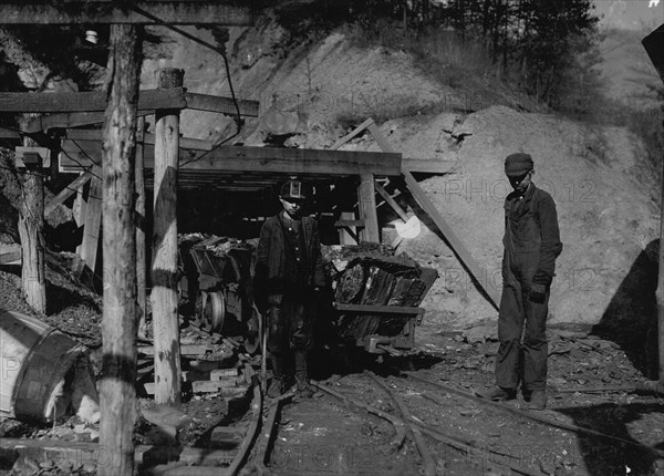 Hard work and dangerous for such a young boy. James O'Dell, a greaser and coupler on the tipple of the Cross Mountain Mine, Knoxville Iron Co., in the vicinity of Coal Creek, Tenn. James has been there four months. Helps push these heavily loaded cars. Appears to be about 12 or 13 years old.  1908