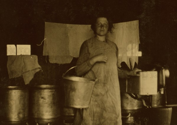 Holding milk pails by a cream separator 1916