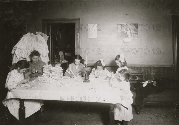 Working on hose supporters.  1912