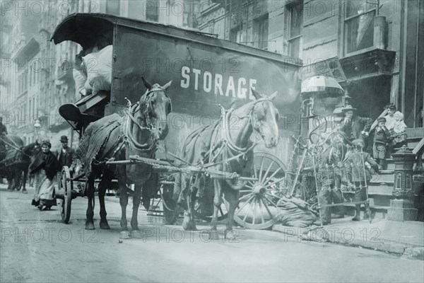 Horse Drawn Wagon with sign saying STORAGE unload the home content of a family being evicted